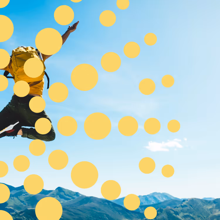 Person mid-jump in mountain landscape with yellow circles
