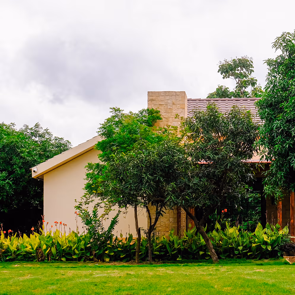 A private villa at Angirasa resort, nestled among lush gardens and trees, offering a permanent luxury accommodation option for a serene getaway near Hyderabad.