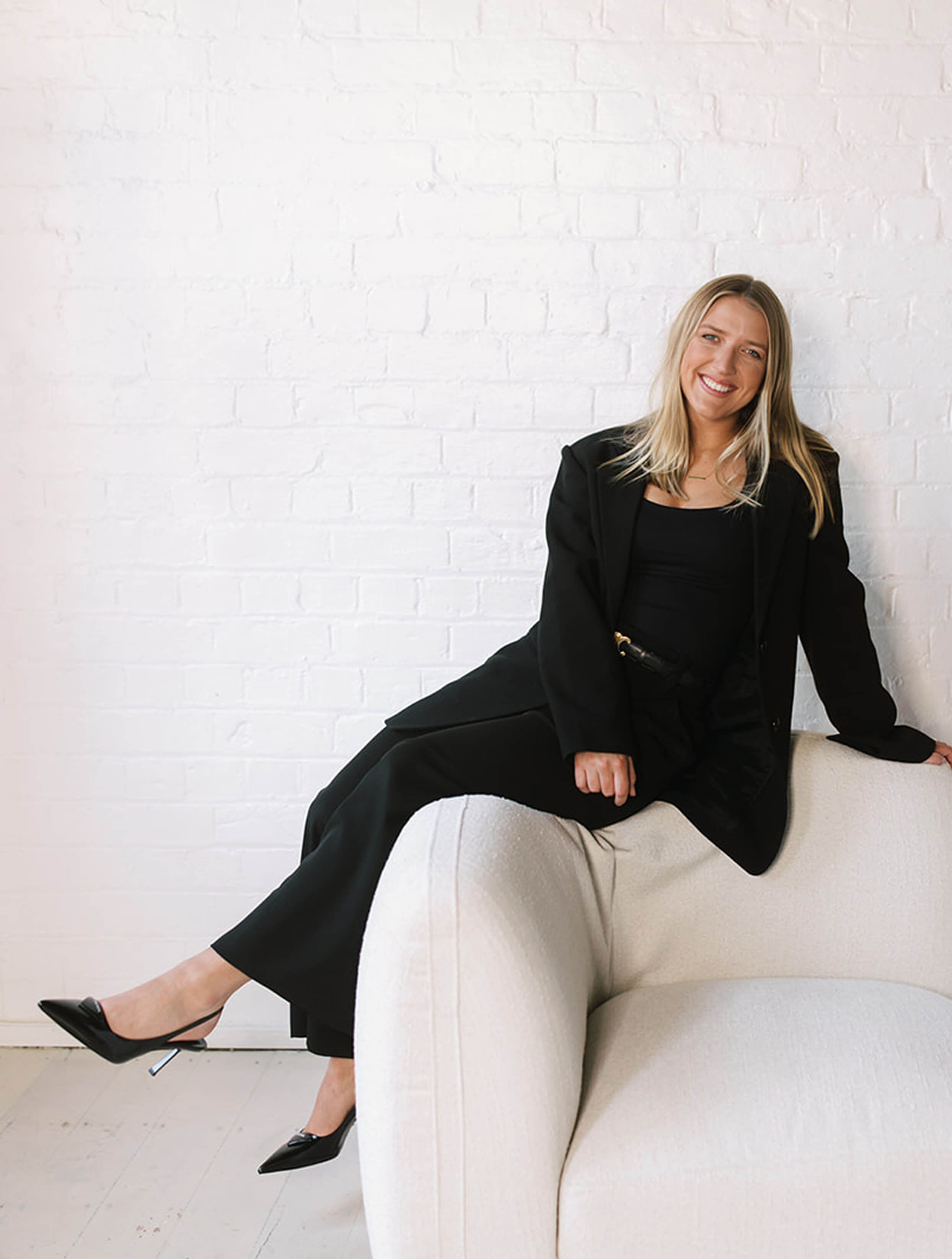 Jillian Wealth's KiwiSaver adviser, Ella Leslie, sitting on a couch.