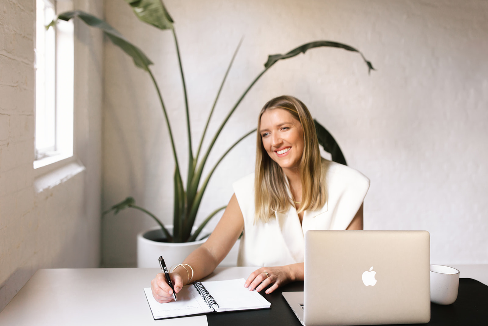 Jillian Wealth's KiwiSaver adviser, Ella Leslie, writing notes from a client meeting.
