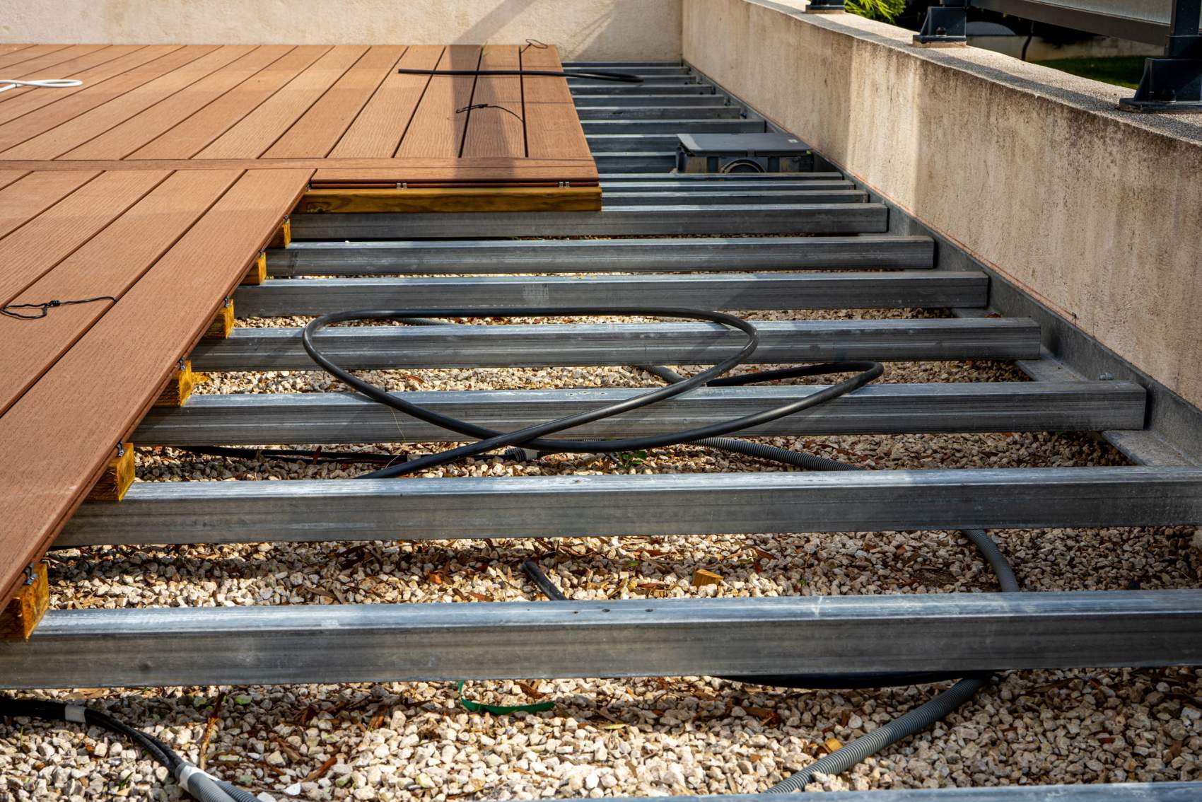 Construction of a wooden terrace on a balcony. A new wooden, timber deck being constructed. City background.