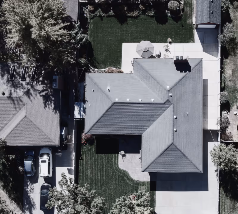 Aerial view of residential home and yard.