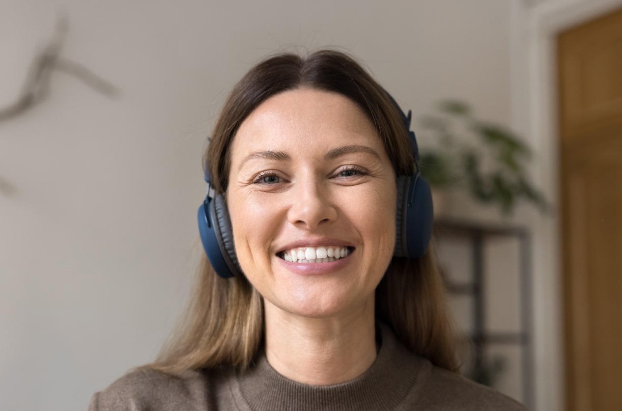Friendly woman on a video call with headphones
