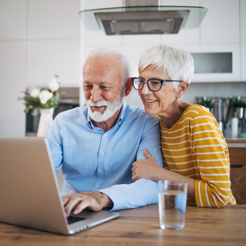 Confident retirees managing their IRA online
