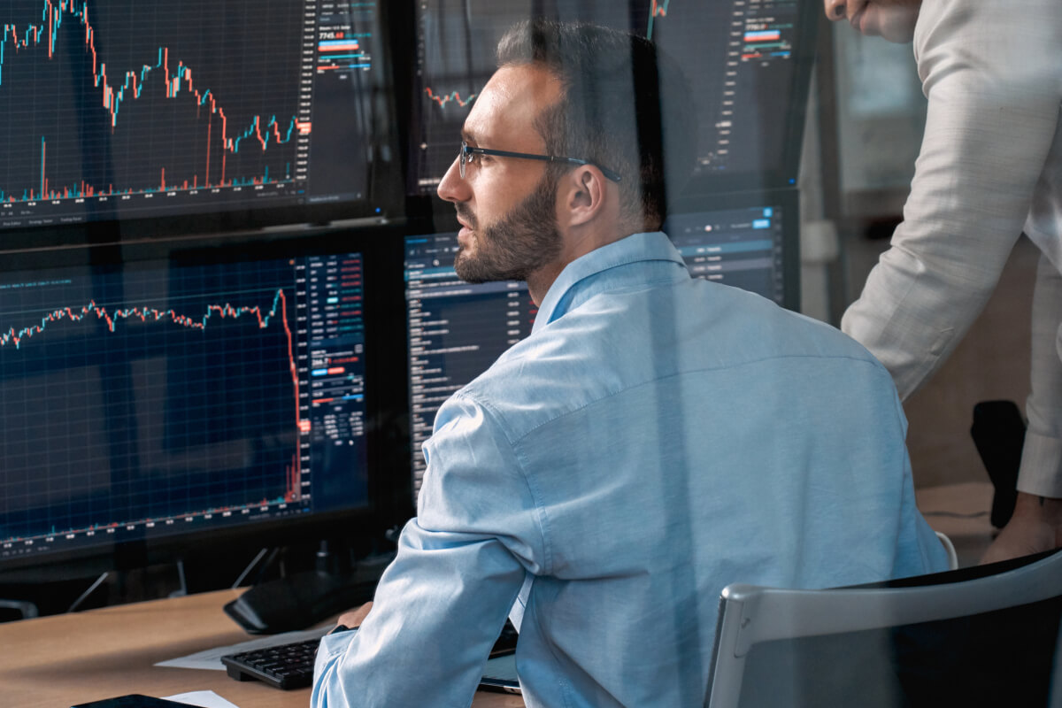 Traders monitoring currency markets on multiple screens