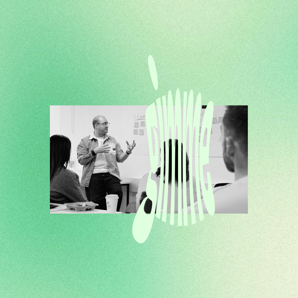 Black and white image of a man speaking and gesturing to a small group in a meeting room with an Apple-shaped graphic overlay reading 'jsnime'.