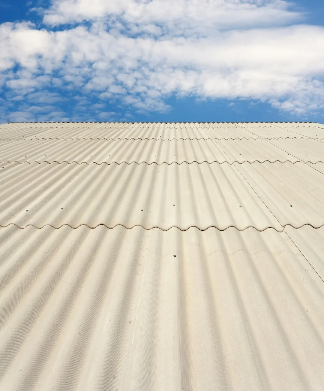 metal roof installed with blue sky and clouds behind