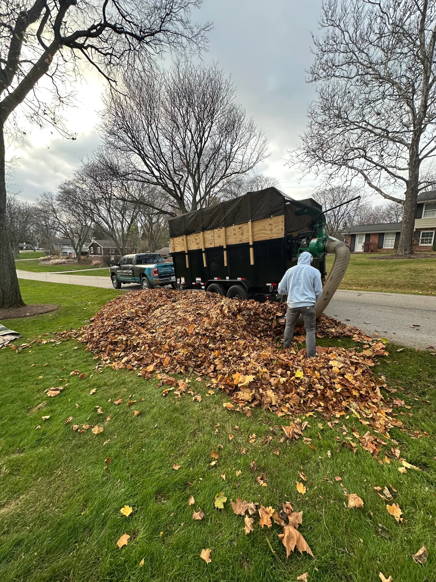 Fall leaf removal and cleanup service using professional equipment by Jake's Lawn Care Michigan