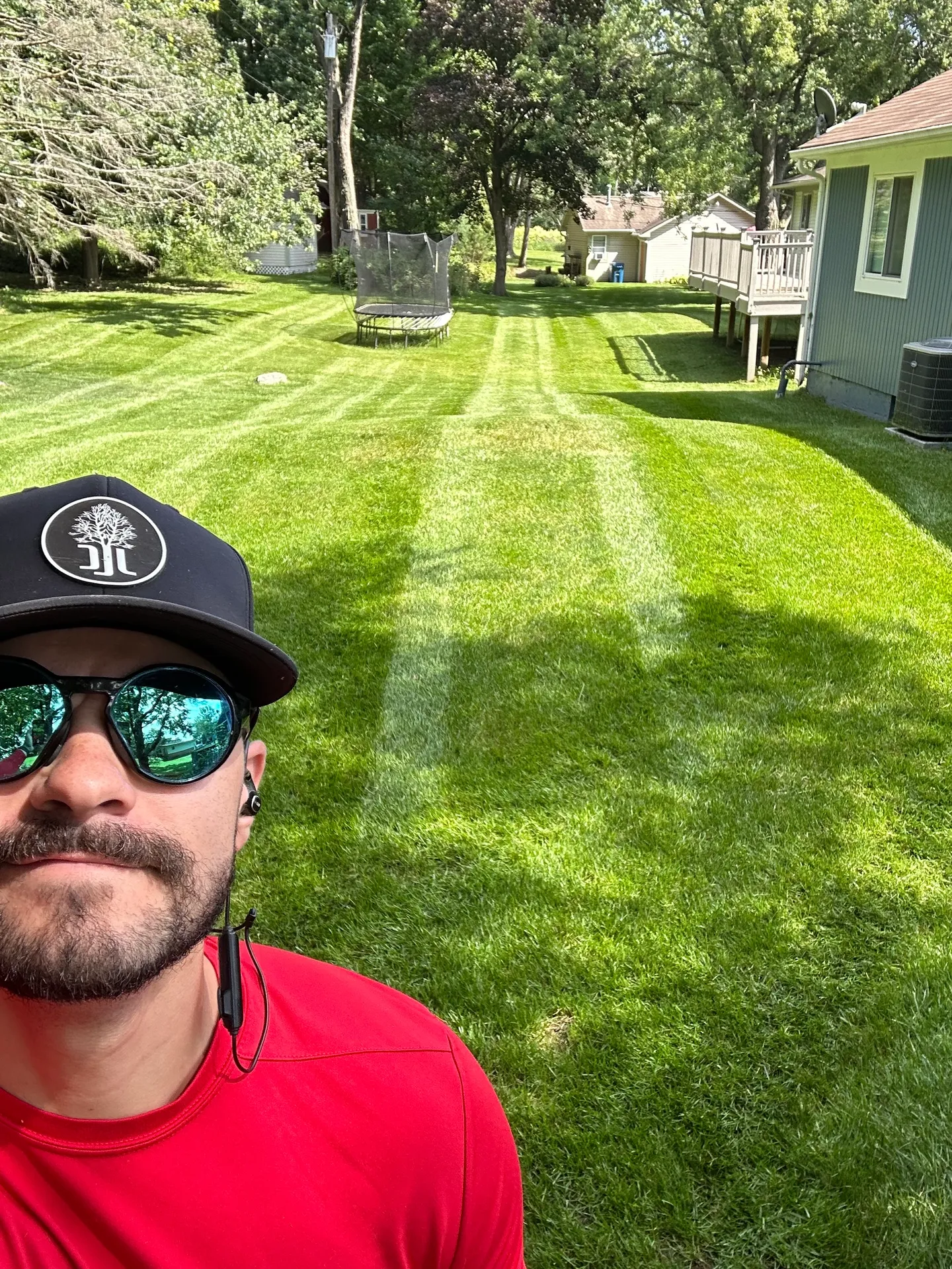 Jake Meissner providing premium residential lawn care service with professional mowing stripes Michigan