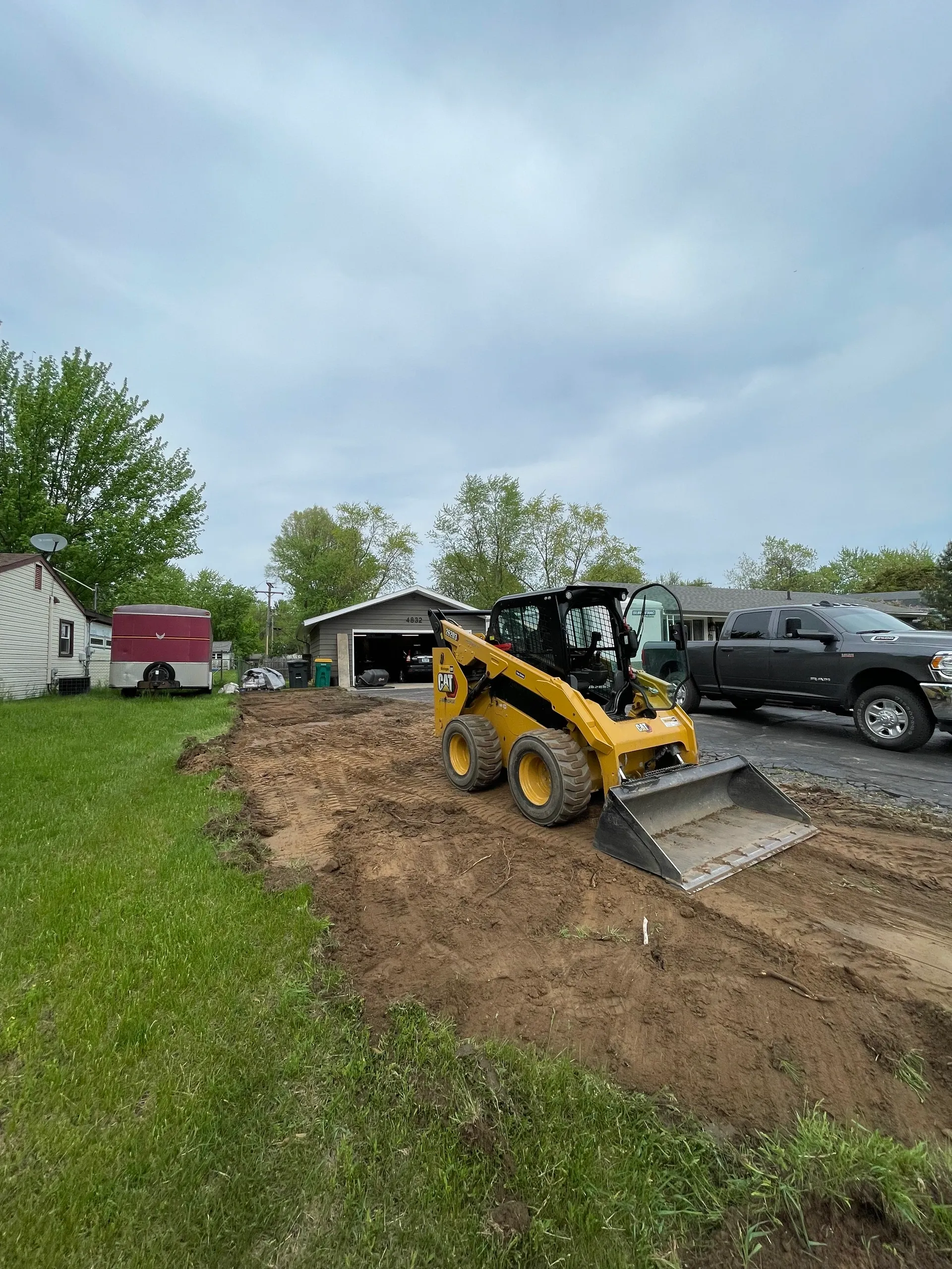 Professional excavation and site preparation services using CAT skid steer by Jake's Lawn Care Michigan