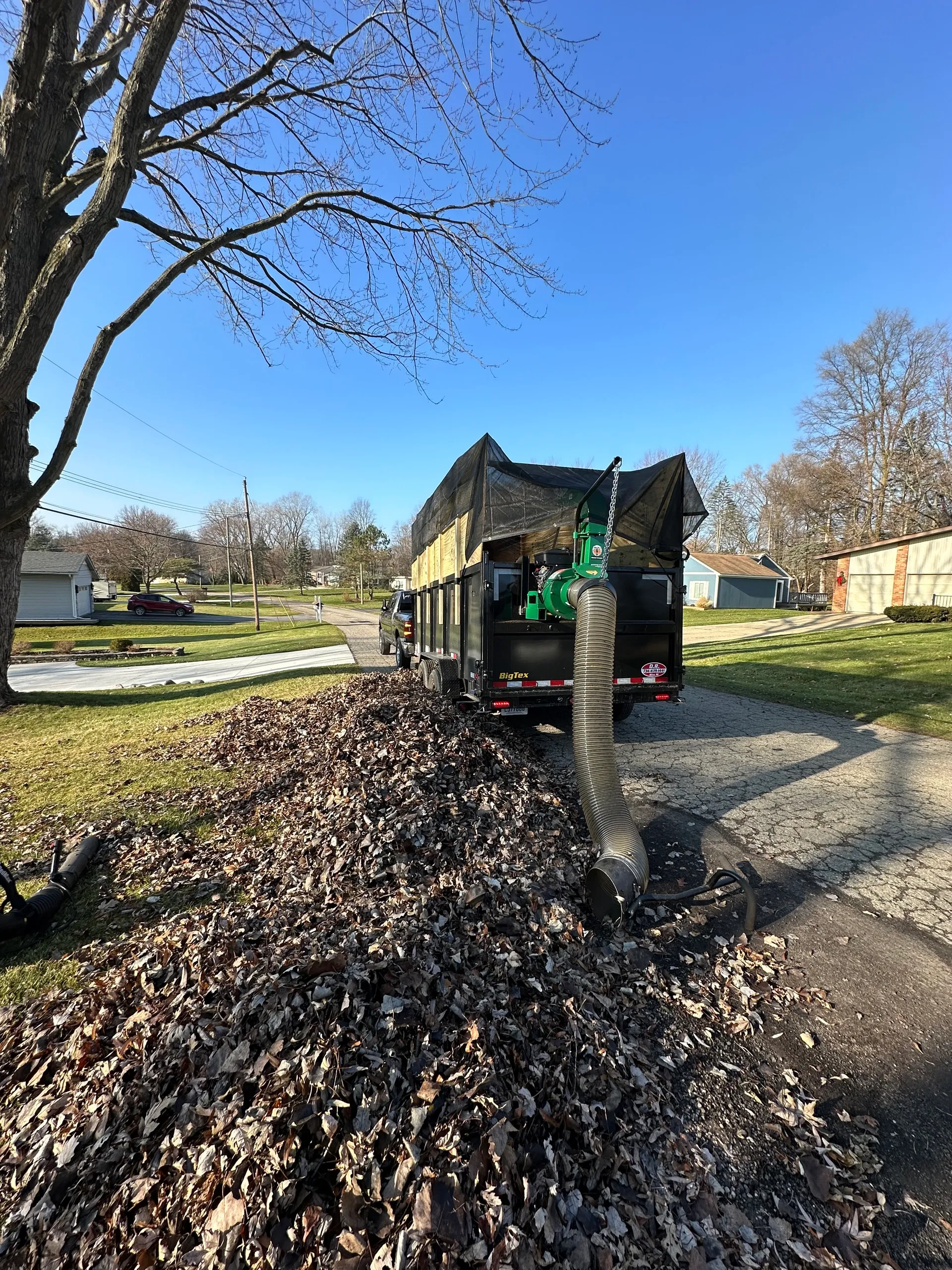 Professional fall leaf removal and cleanup service with specialized vacuum equipment by Jake's Lawn Care Michigan