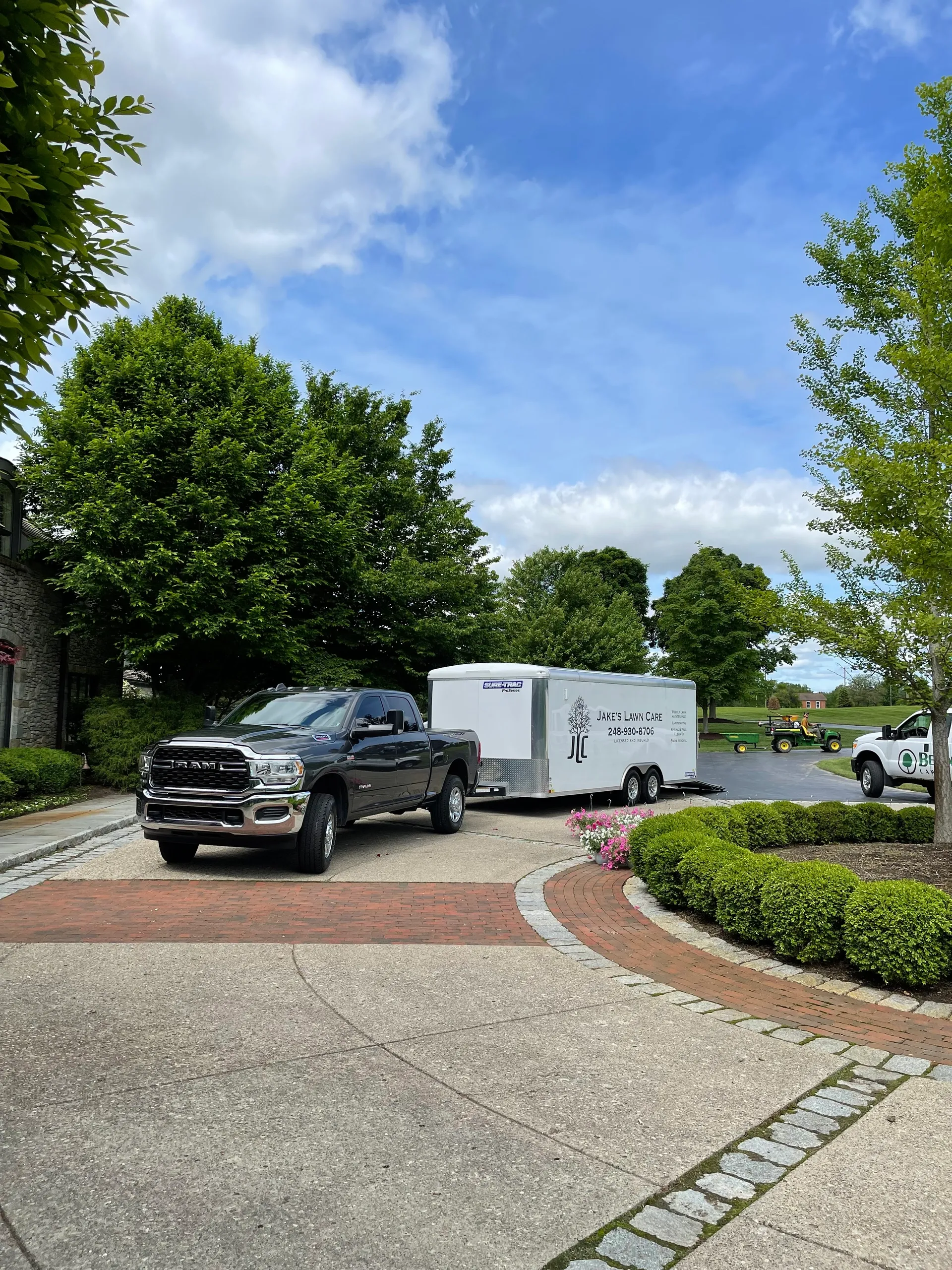 Jake's Lawn Care professional equipment trailer and crew providing comprehensive lawn maintenance Michigan
