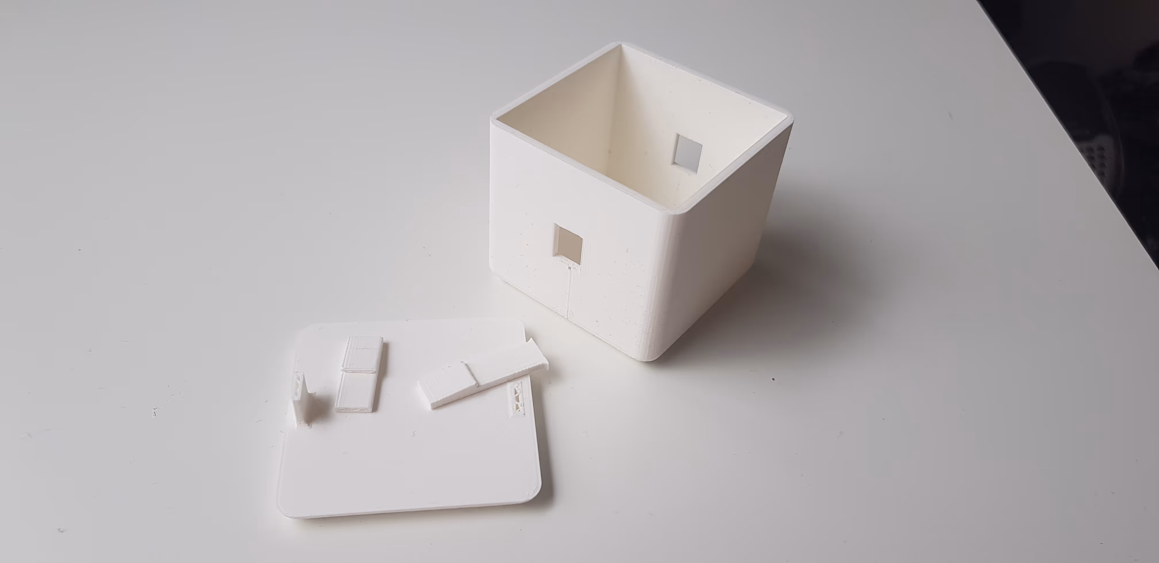 A photo of one of the 3D printed prototypes of the box, showing how easily the mechanism breaks