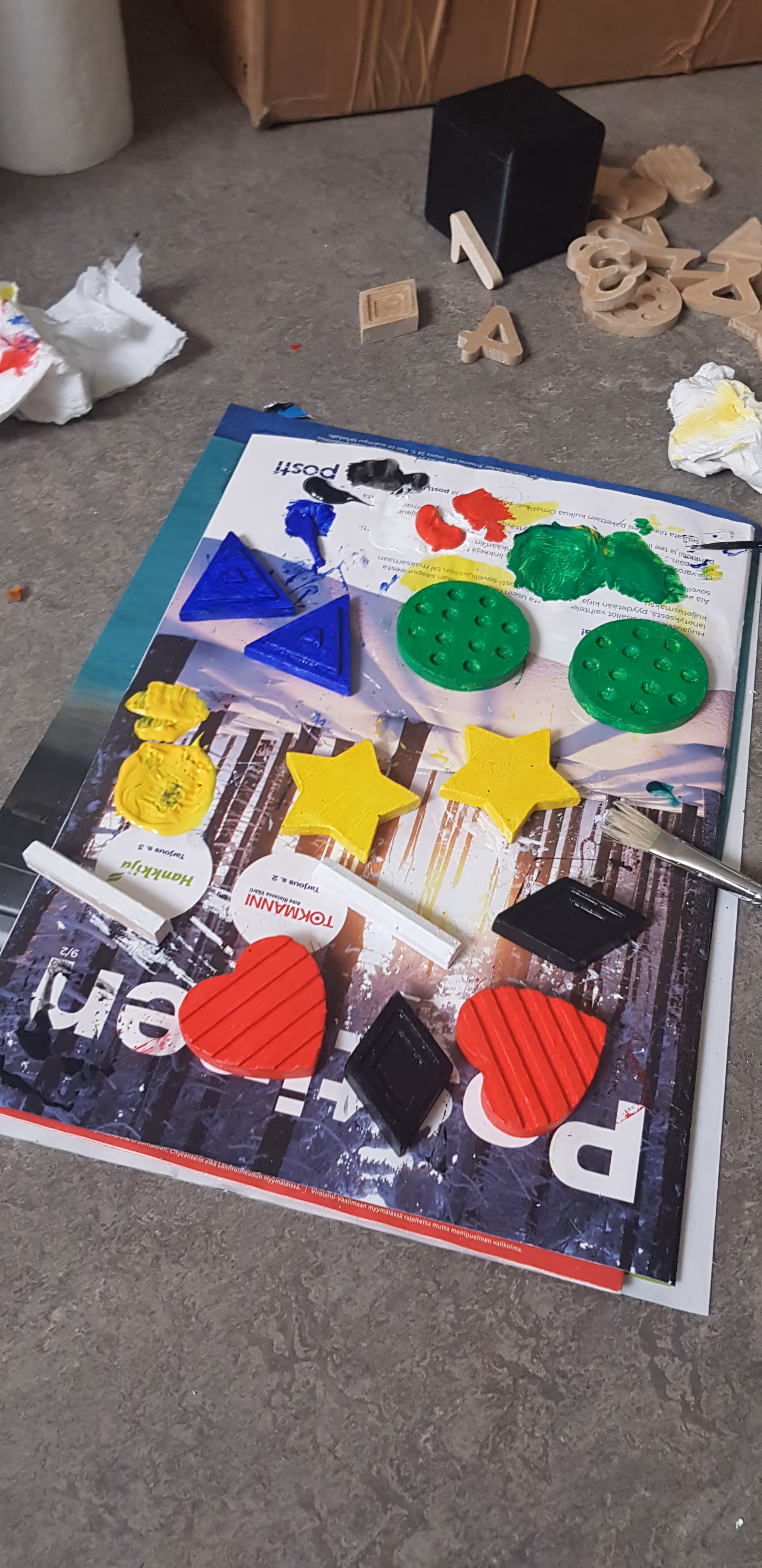 A photo of the labels of the board being colored with a paintbrush