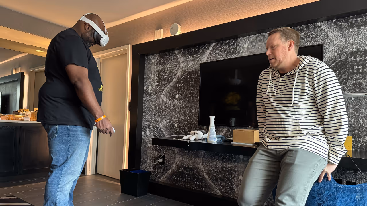Two men playing a video game in a room. -  ÜberStrategist Images