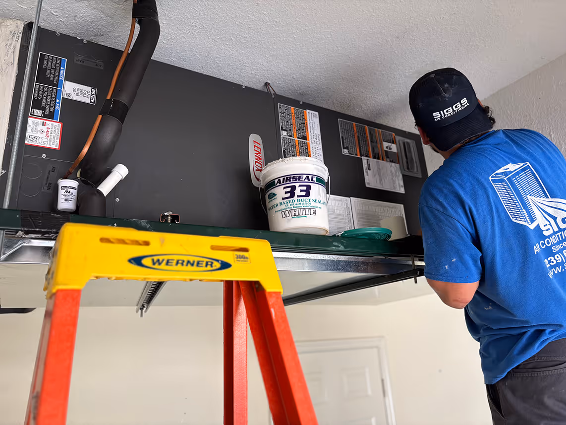 A Siggs Air Conditioning technician installs an air handling unit
