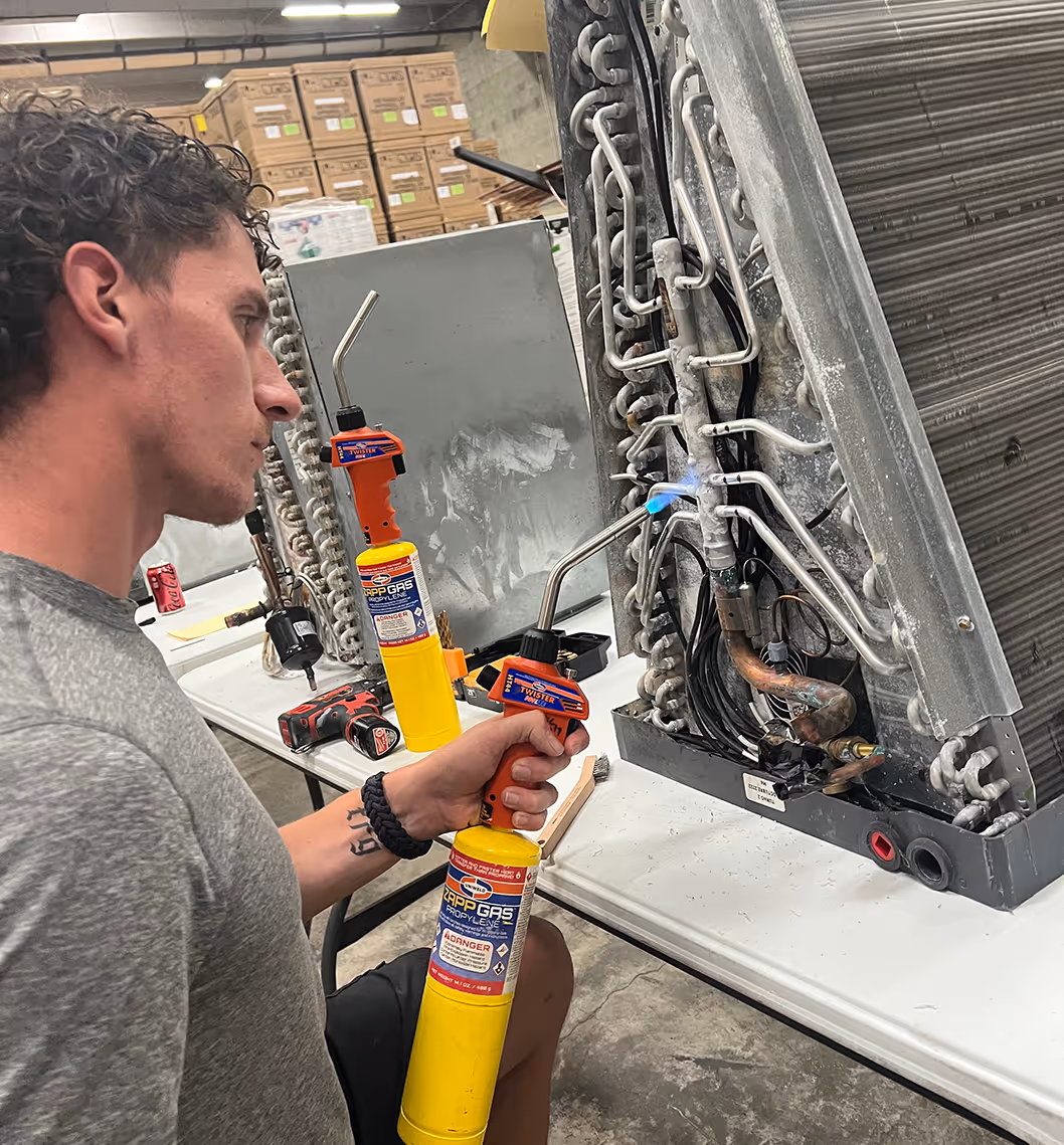 An air conditioning technician training coil weld repair techniques 