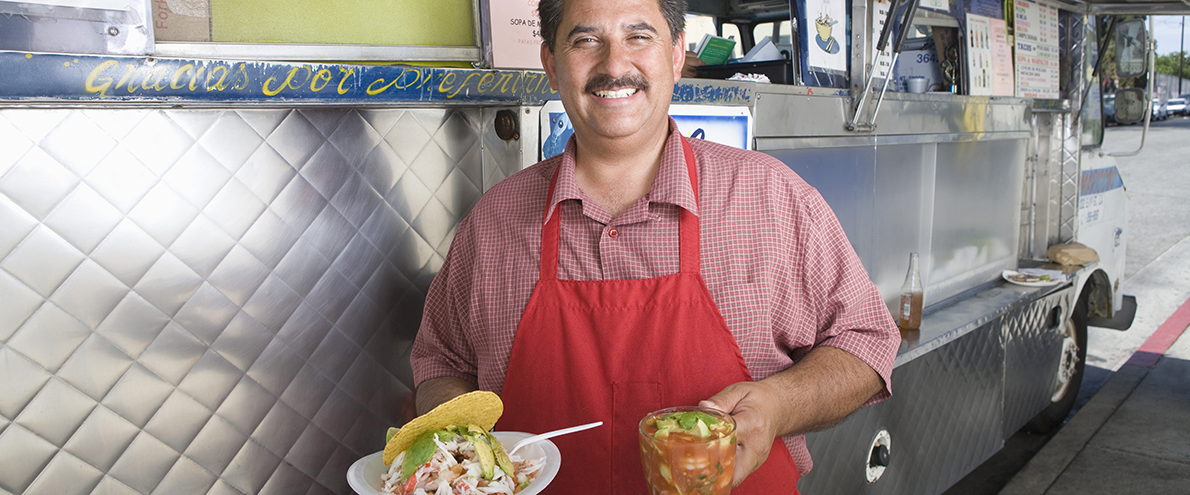 latin chef holding specialty dishes