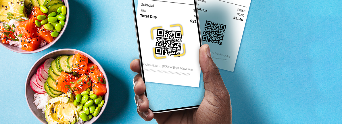 Using a phone to scan QR code to pay for meal, two poke bowls in the background