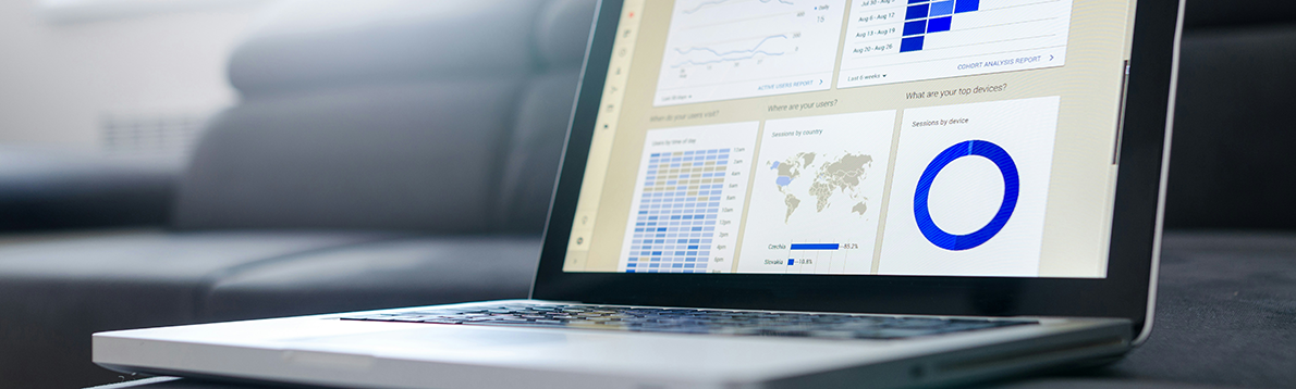 laptop open with a dashboard of graphs on the screen
