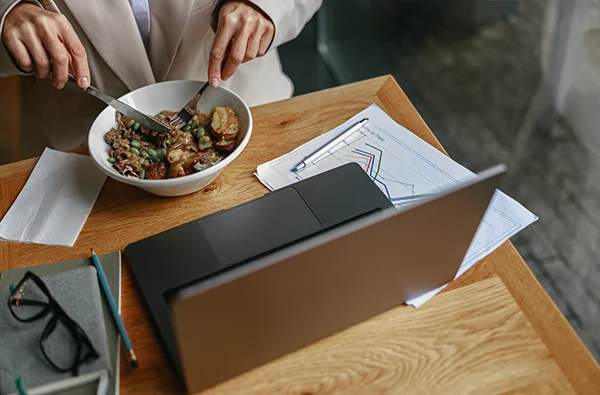 Close up of businesswoman is having a business lunch during working day in cafe.