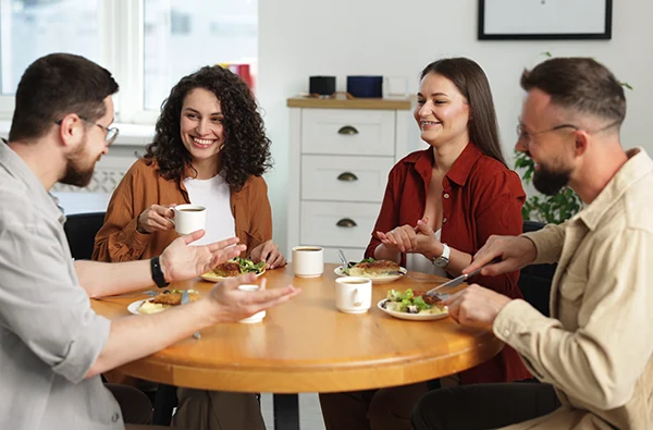 Colleagues chatting during lunch break in office