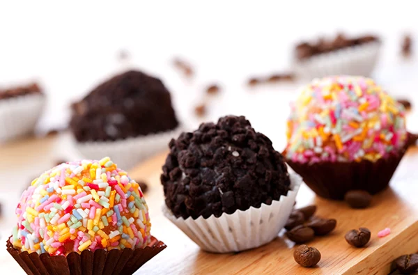 photo of colorful dessert truffles displayed on a wooden board