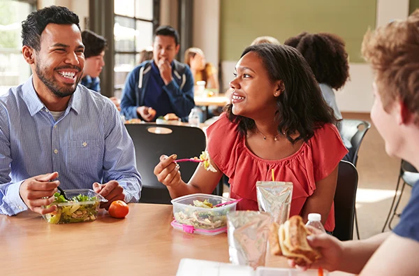 photo of coworkers eating lunch in a cafeteria