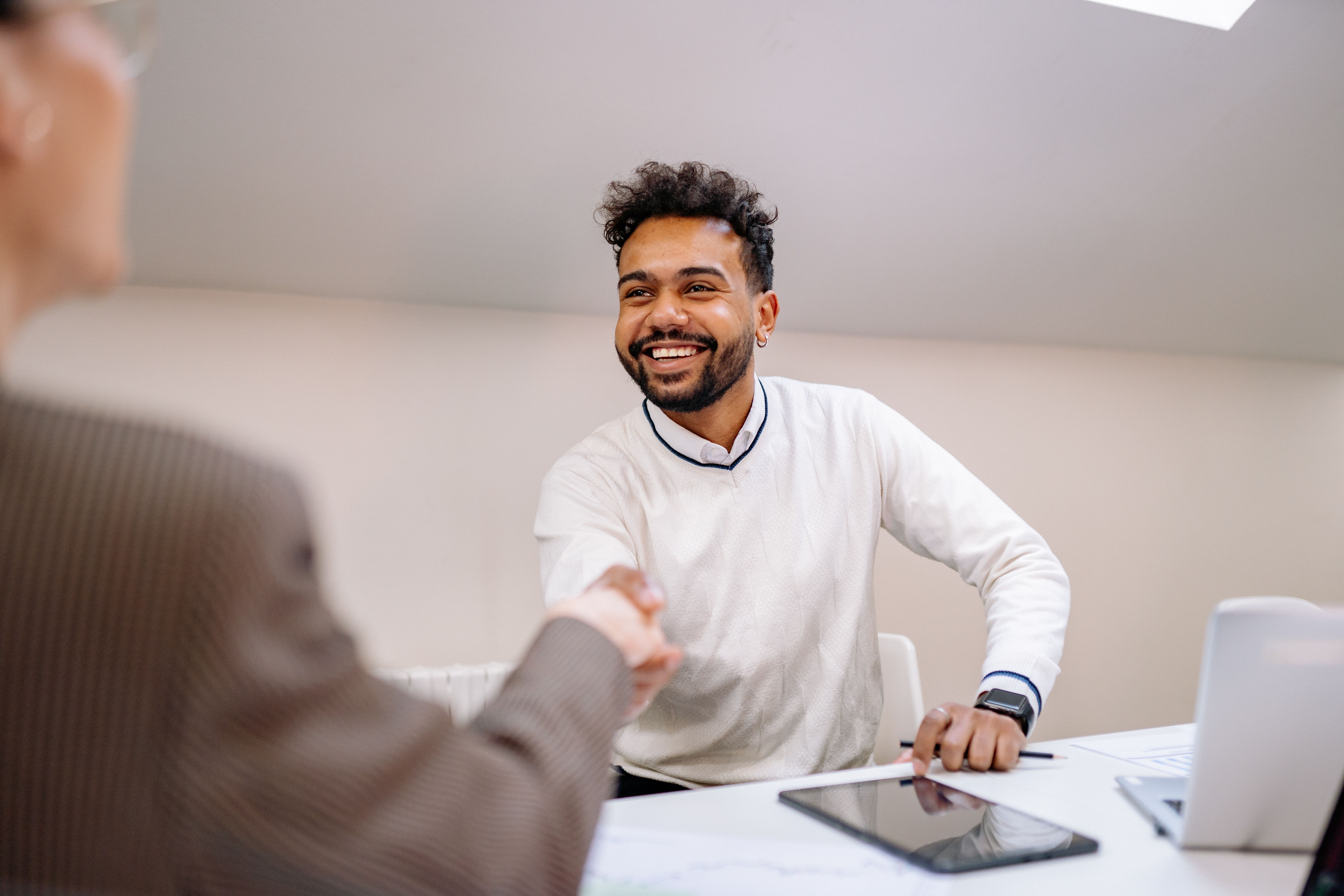 Employee shaking hands with a customer