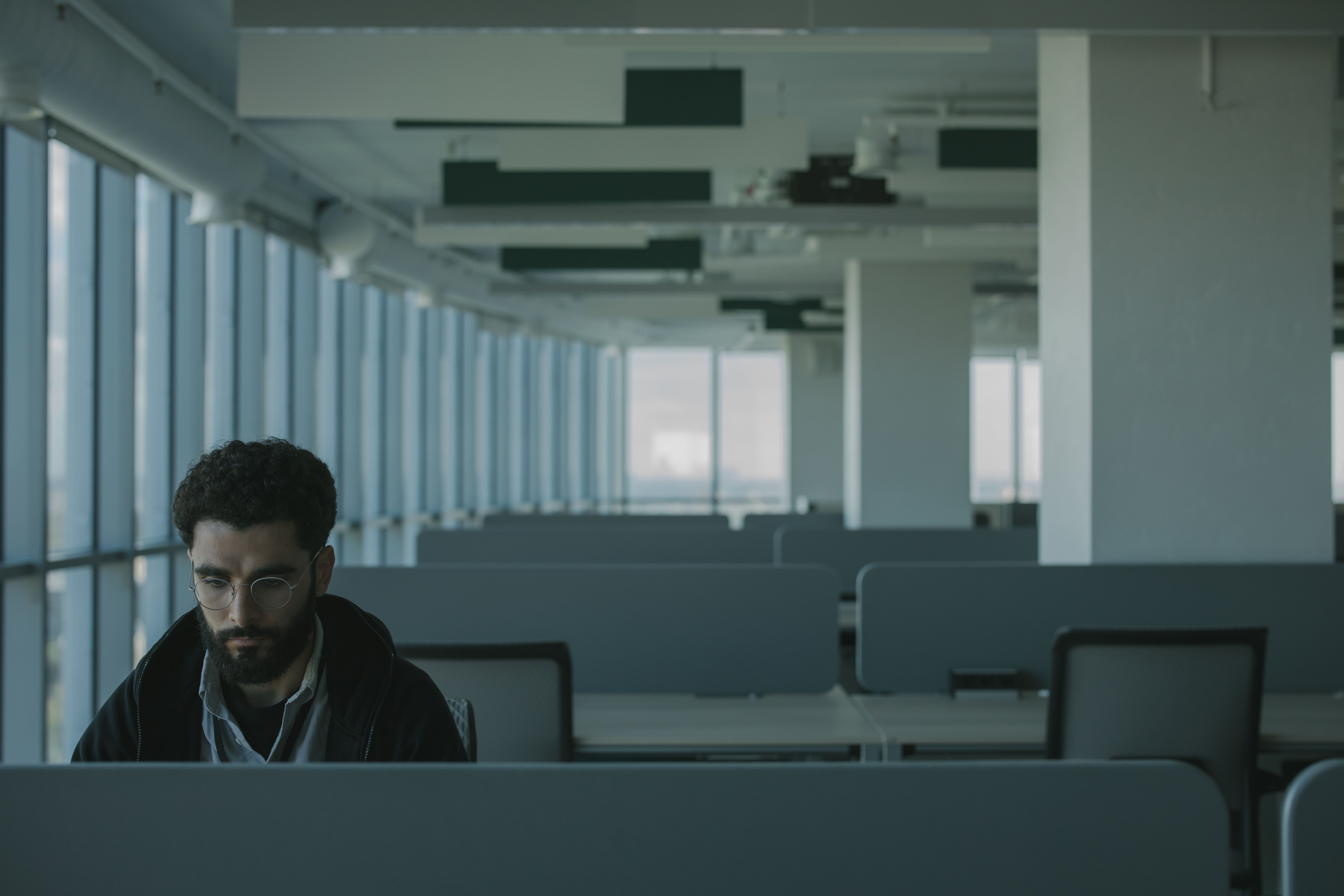 Lonely employee sitting in empty office