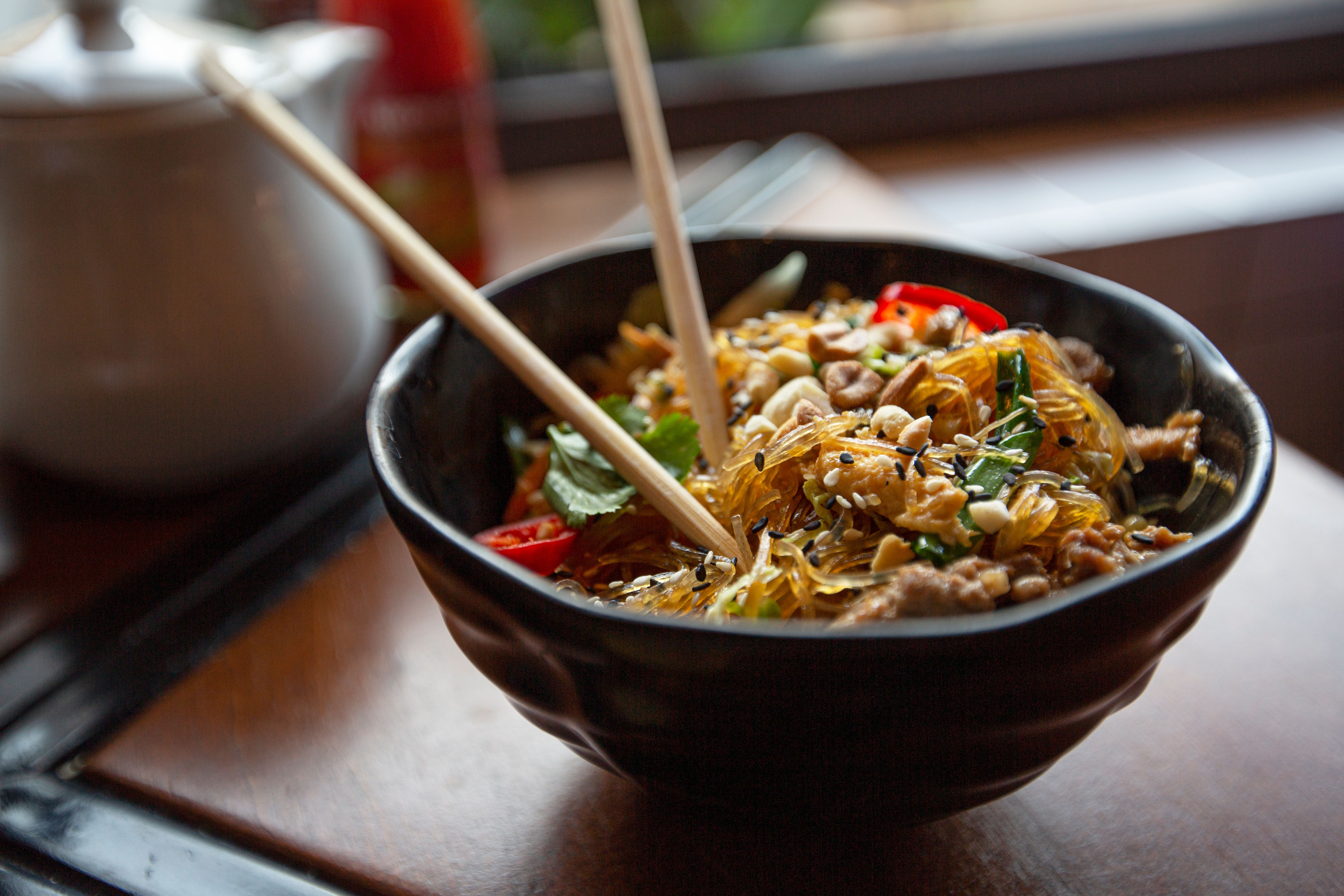 Bowl of Asian food with chopsticks