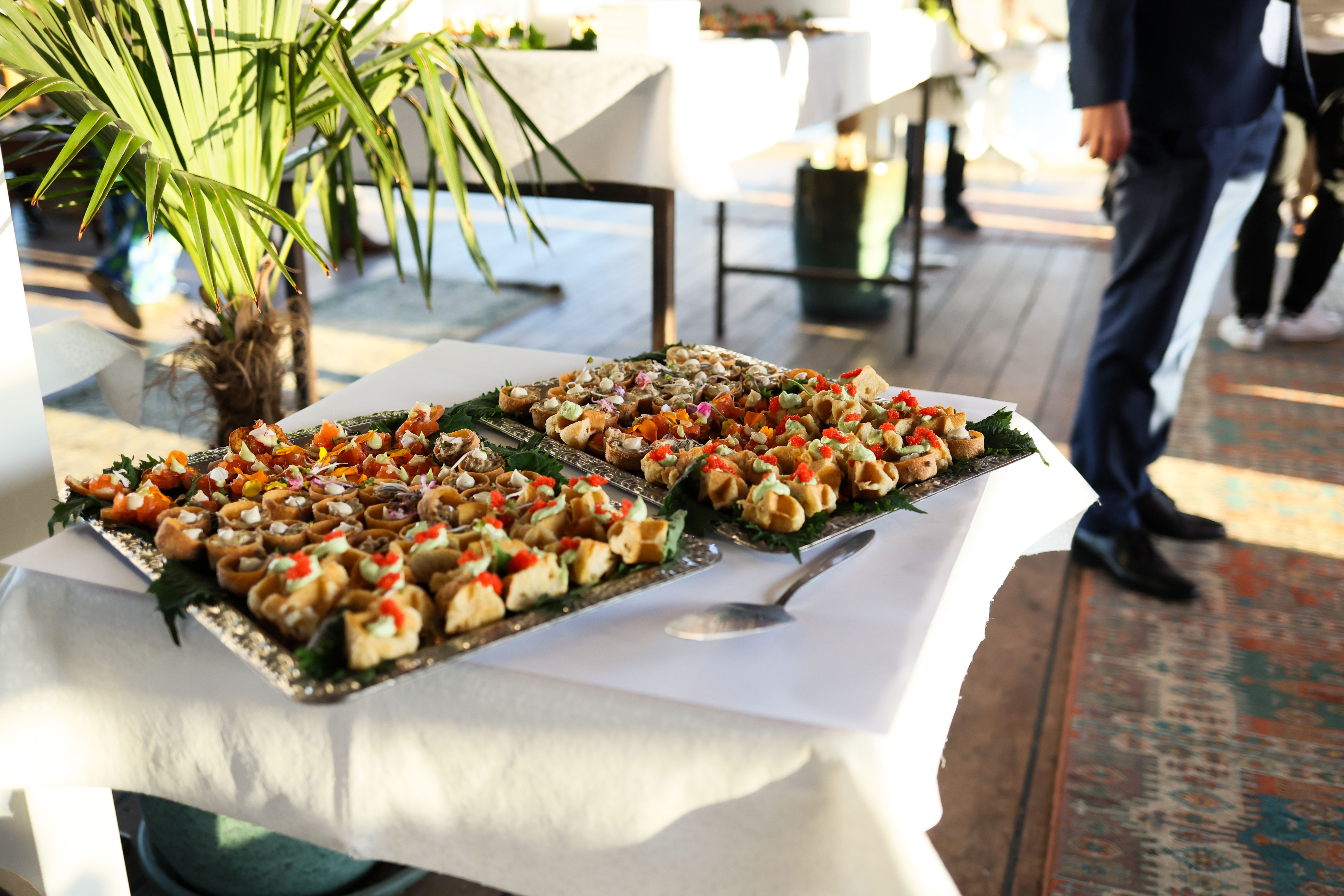 Catering trays full of food sitting on table