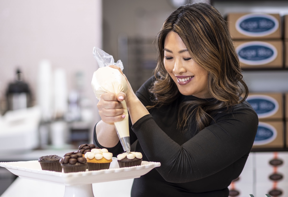 Sugar Bliss owner and CEO Teresa Ging decorating cupcakes
