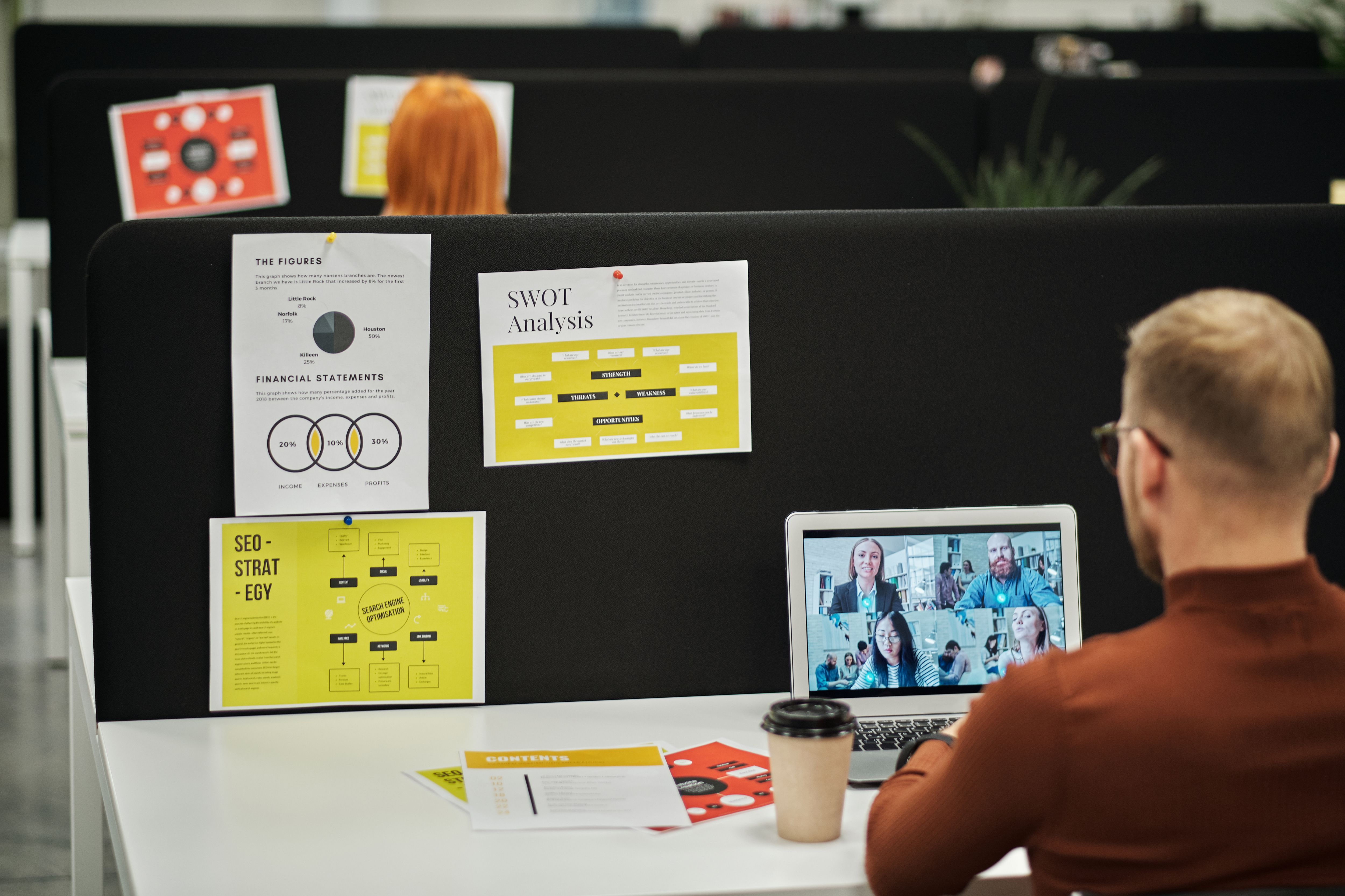 Employee in the office on a video call with coworkers working remote