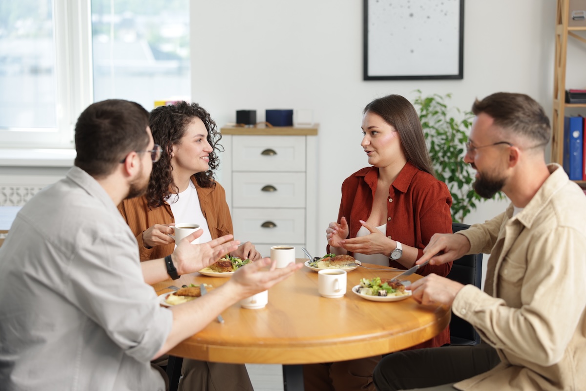 Coworkers enjoying a meal together at work