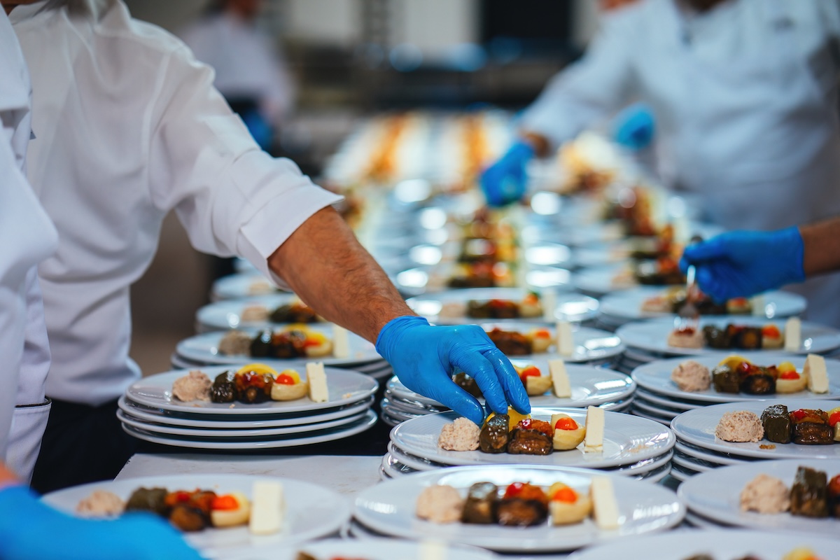 Caterers plating dishes to be served