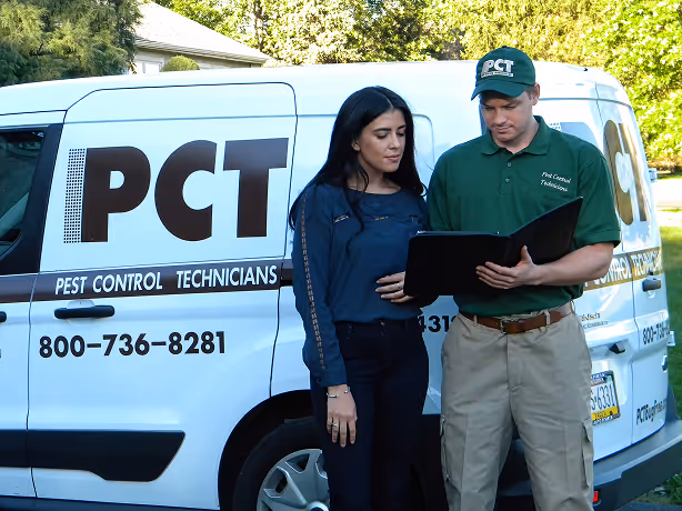 PCT technician reviewing pest control services with a resident in Quakertown, PA.