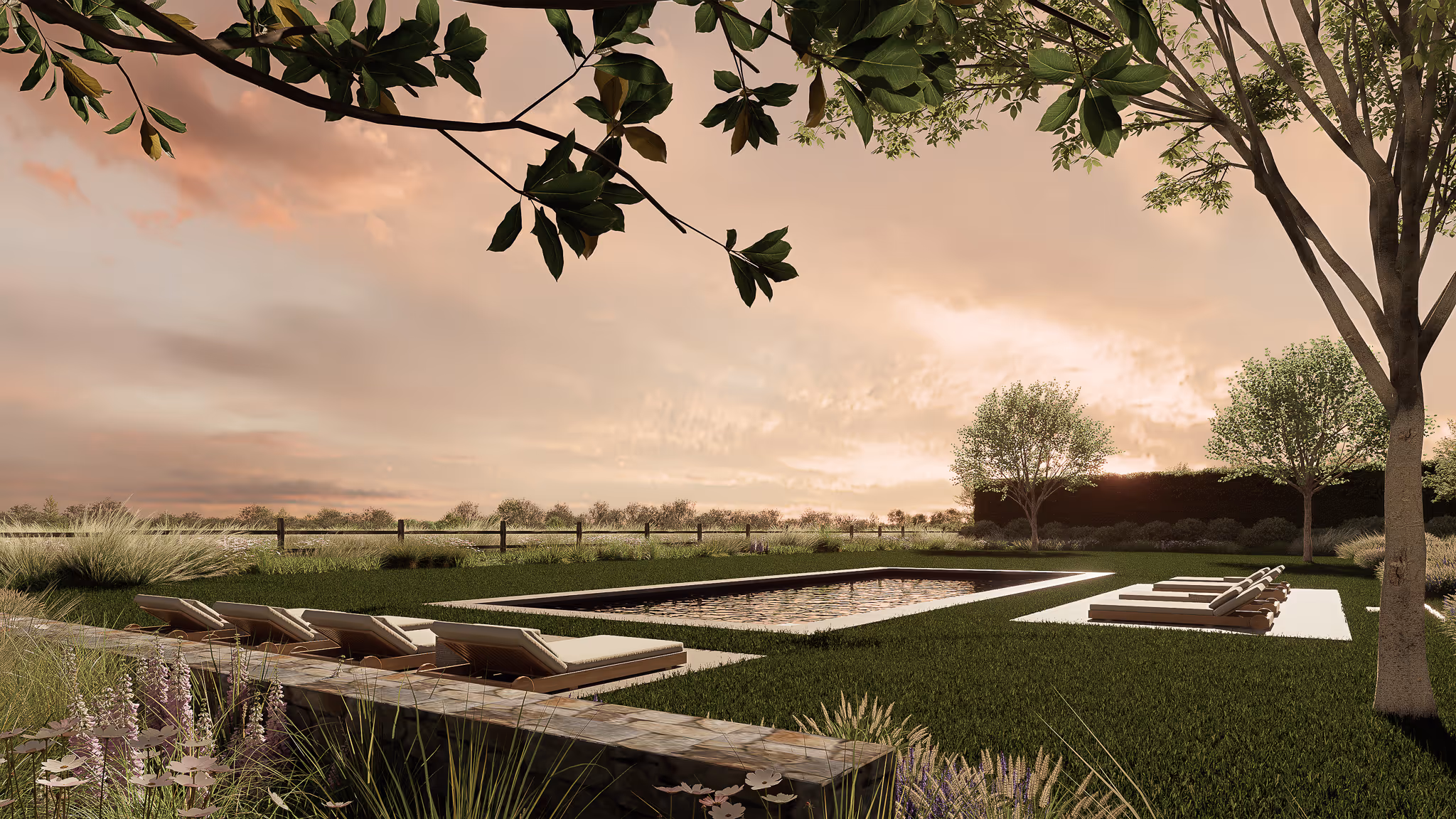 Outdoor rectangular swimming pool surrounded by lush green grass, lounge chairs on both sides, and trees under a pink and orange sunset sky.