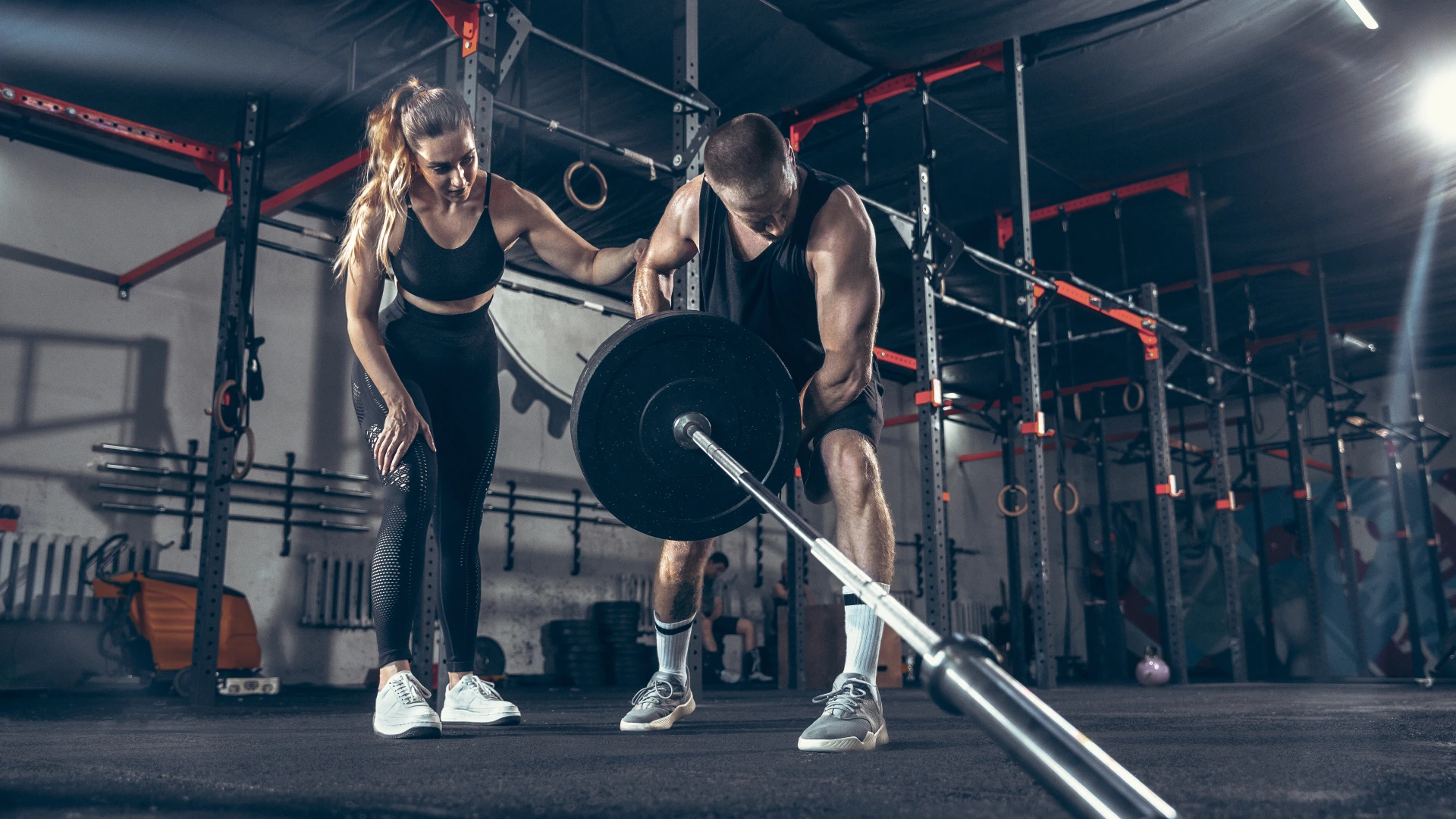A man and woman perform a barbell lift together in a gym at Crossfit Encore, Sycamore, IL.