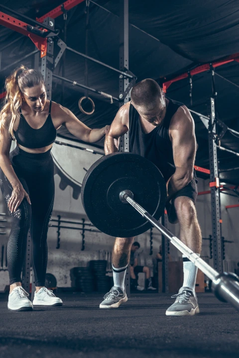 A man and woman perform a barbell lift together in a gym at Crossfit Encore, Sycamore, IL.