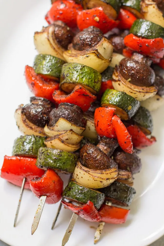 balsamic grilled vegetable kebabs on a white plate