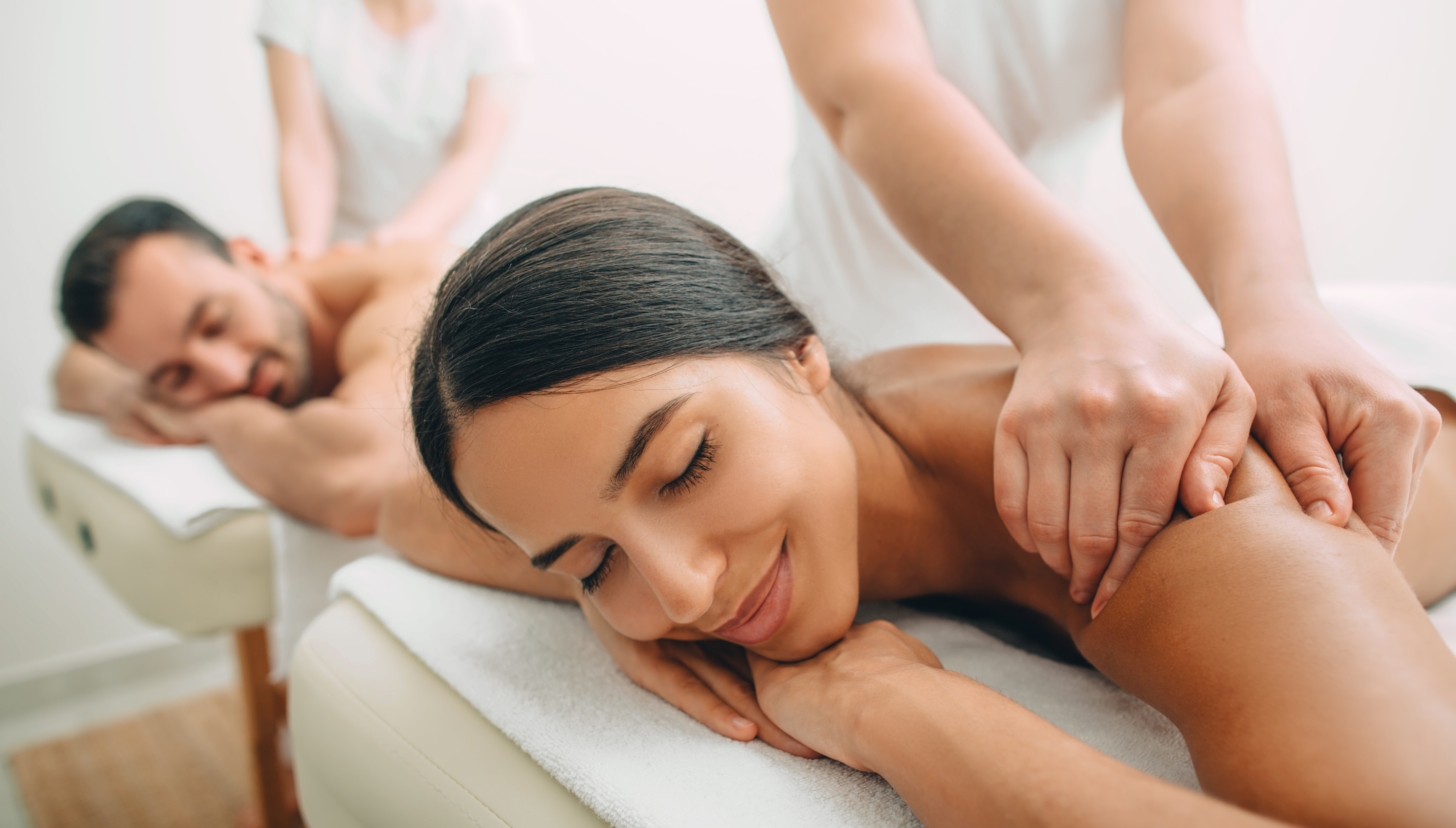 Busy spa front desk during peak weekend hours with guests being welcomed