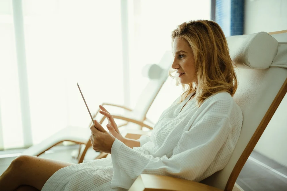 Spa receptionist using modern management software to enhance the guest check-in experience