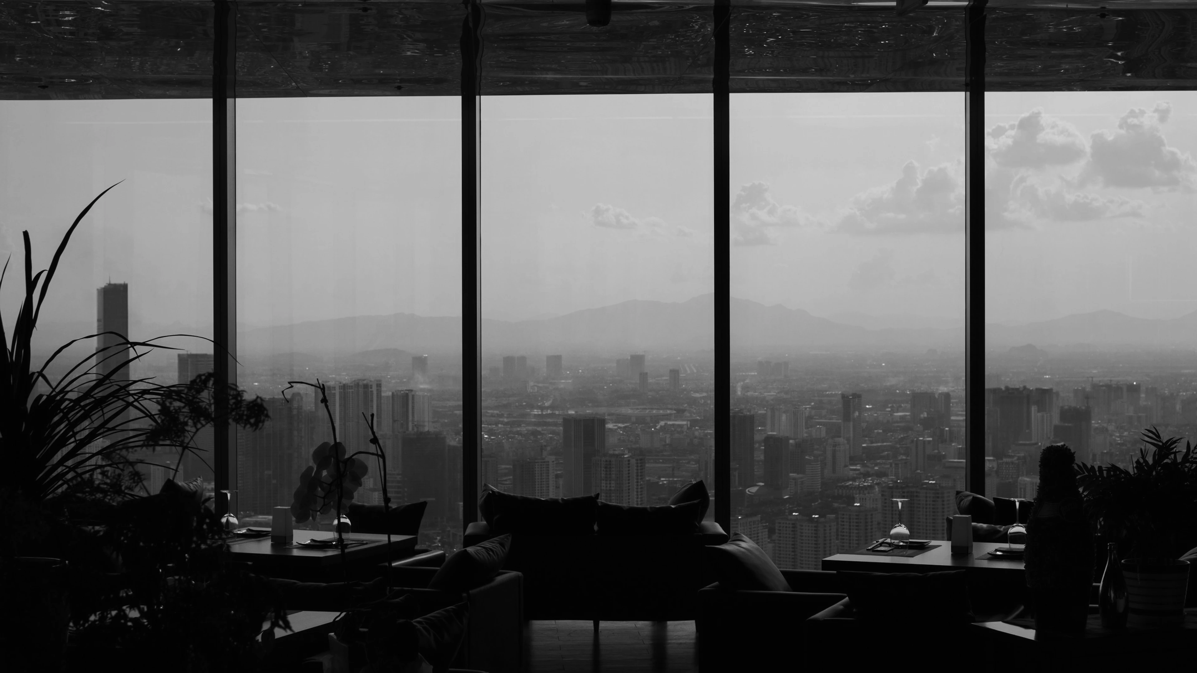 High-floor fine dining restaurant with panoramic city views and elegant modern design