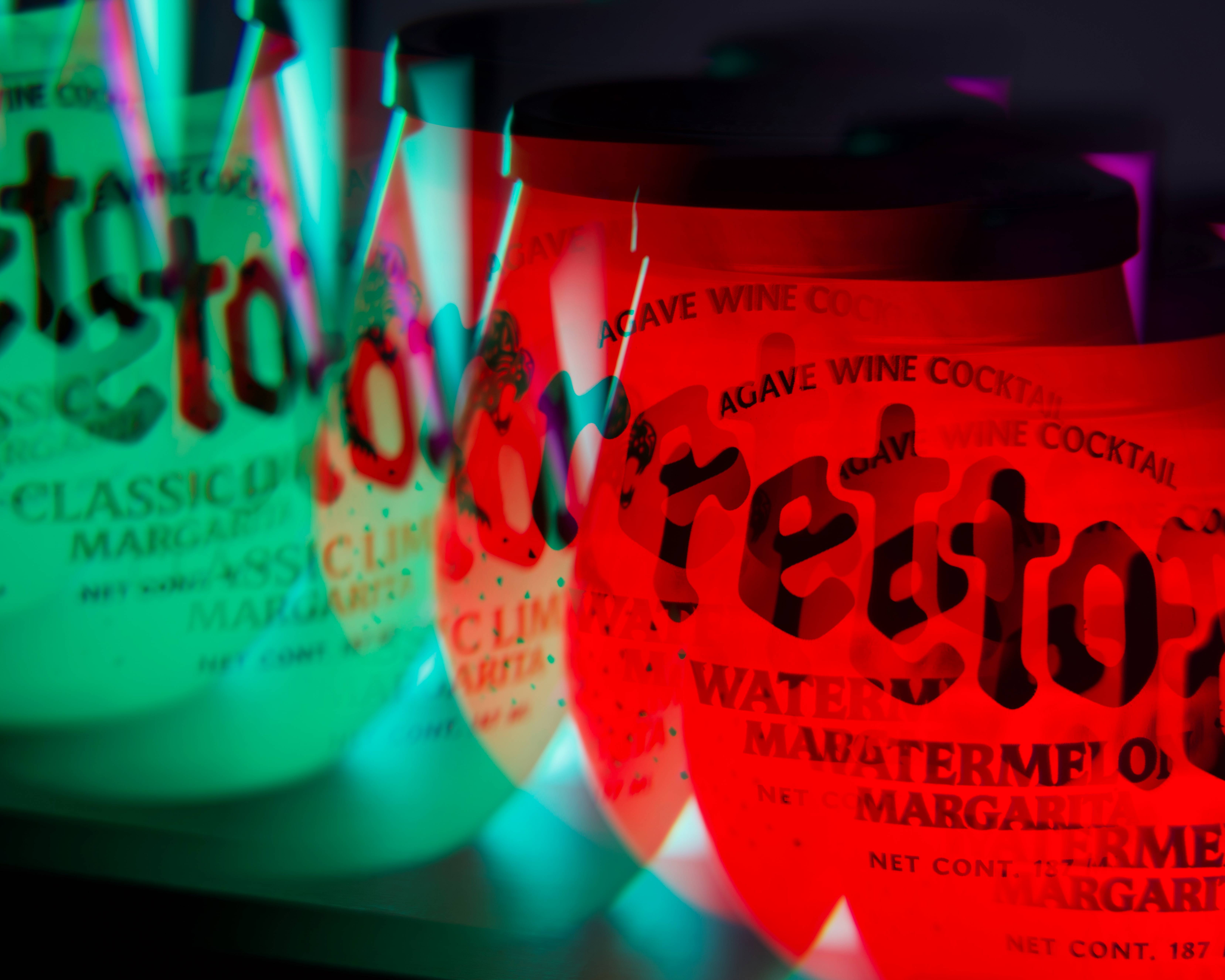 A long exposure photograph of a Classic Lime Margarita Retox and Watermelon Margarita Retox cups.