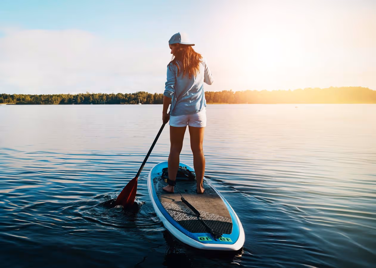 Young woman on a paddleboard on the lake.