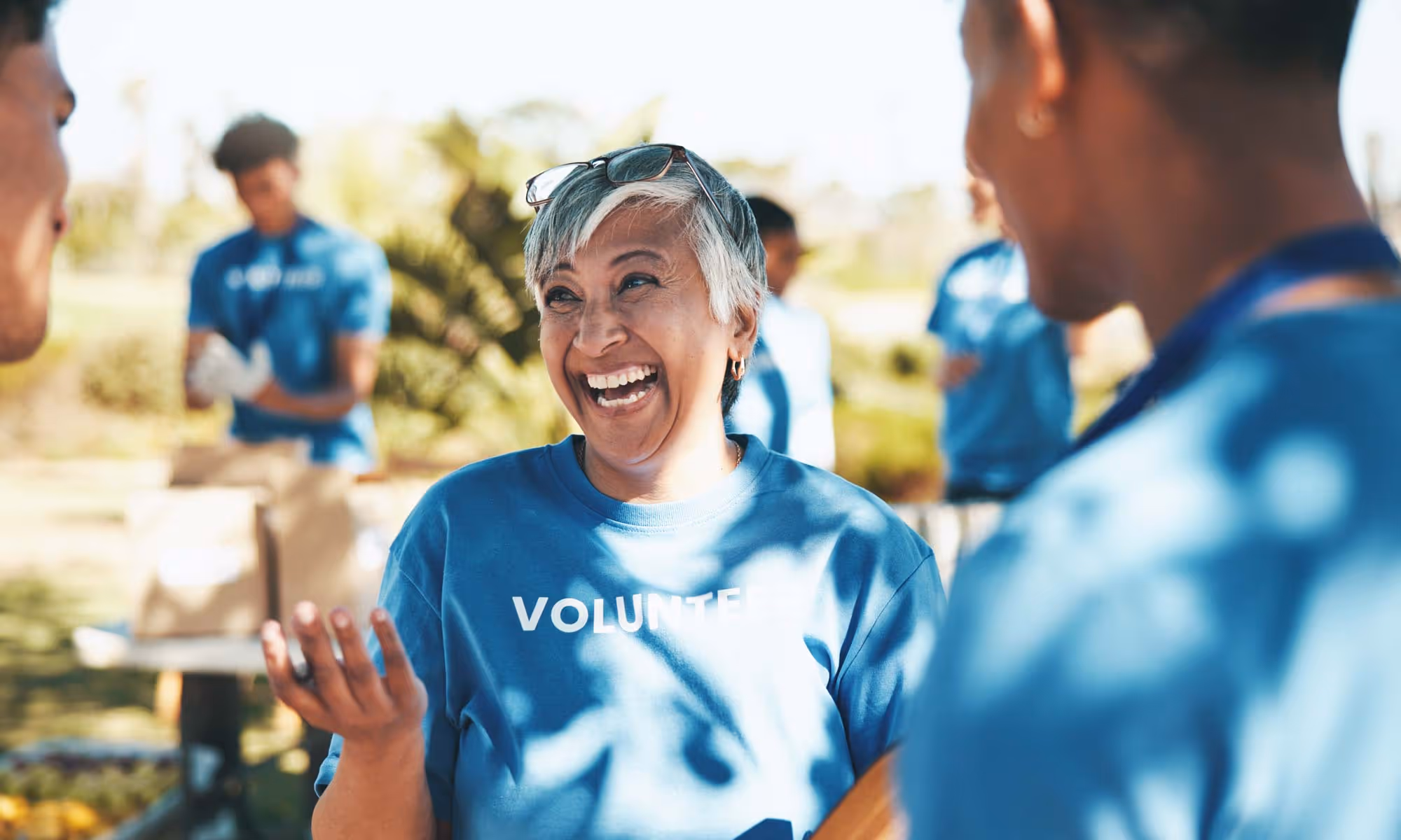 Happy volunteers laughing and smiling outdoors