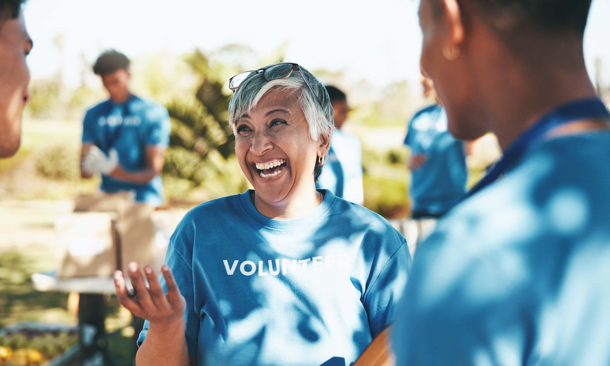 Happy volunteers laughing and smiling outdoors
