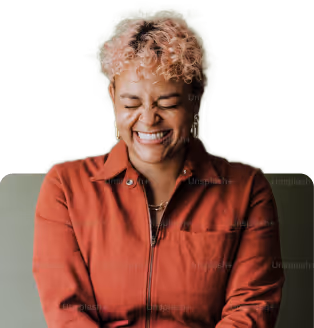  A Black woman with short, curly hair smiles with her eyes closed in a moment of peace or happiness.