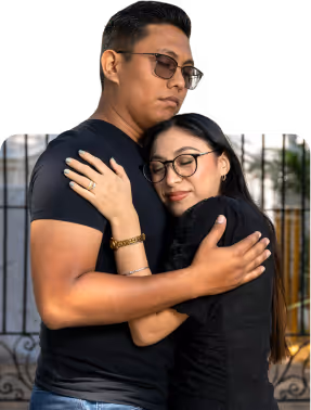 A man and woman share an intimate hug.